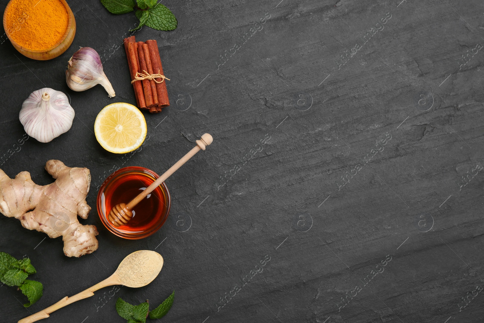 Photo of Flat lay composition with fresh products on black table, space for text. Natural antibiotics