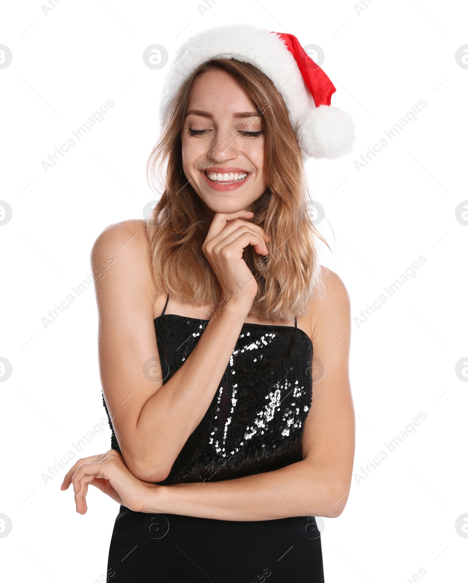 Photo of Happy young woman in Santa hat on white background. Christmas celebration