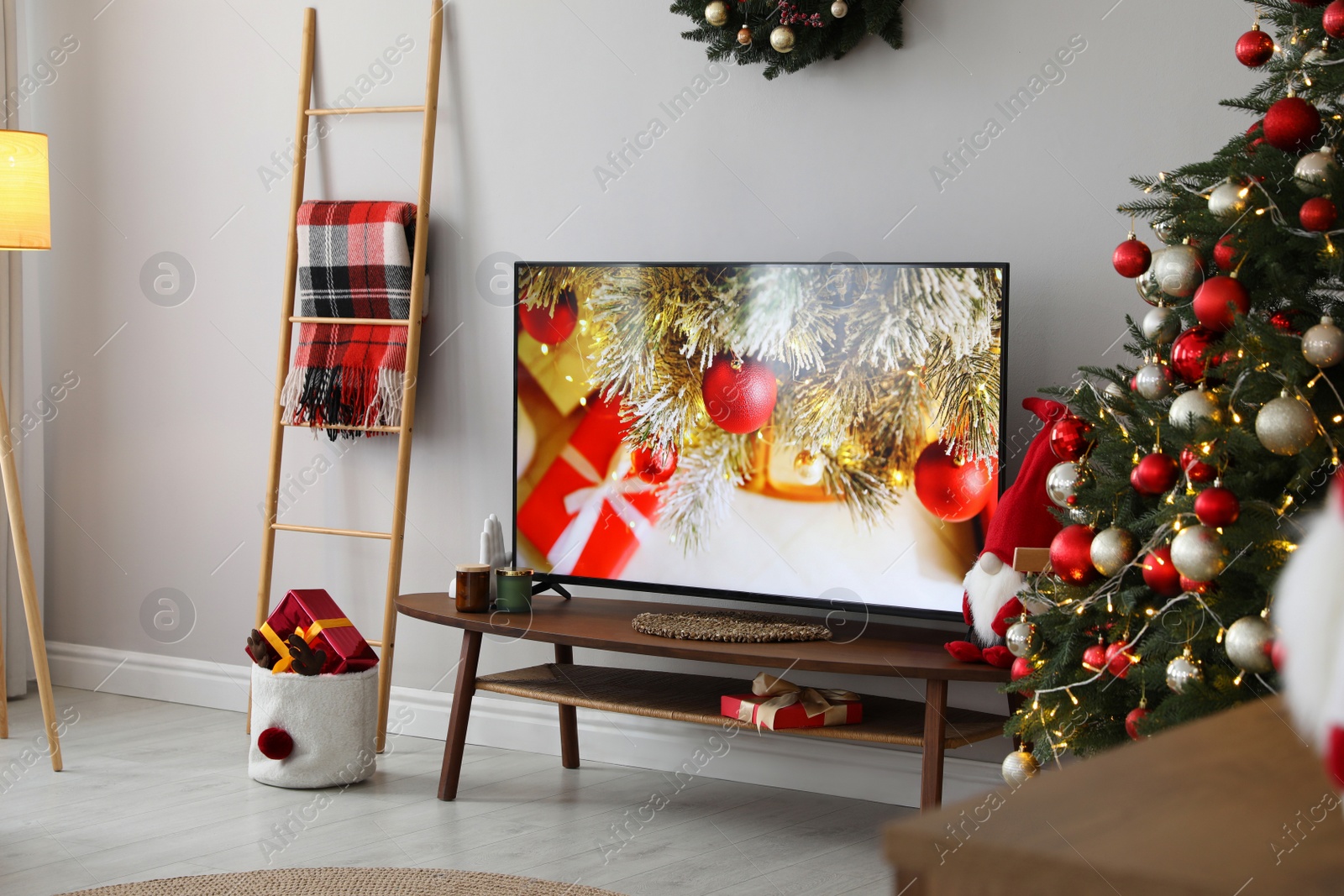 Photo of Stylish living room interior with modern TV and Christmas tree