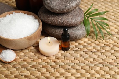 Beautiful spa composition with essential oil on wicker mat