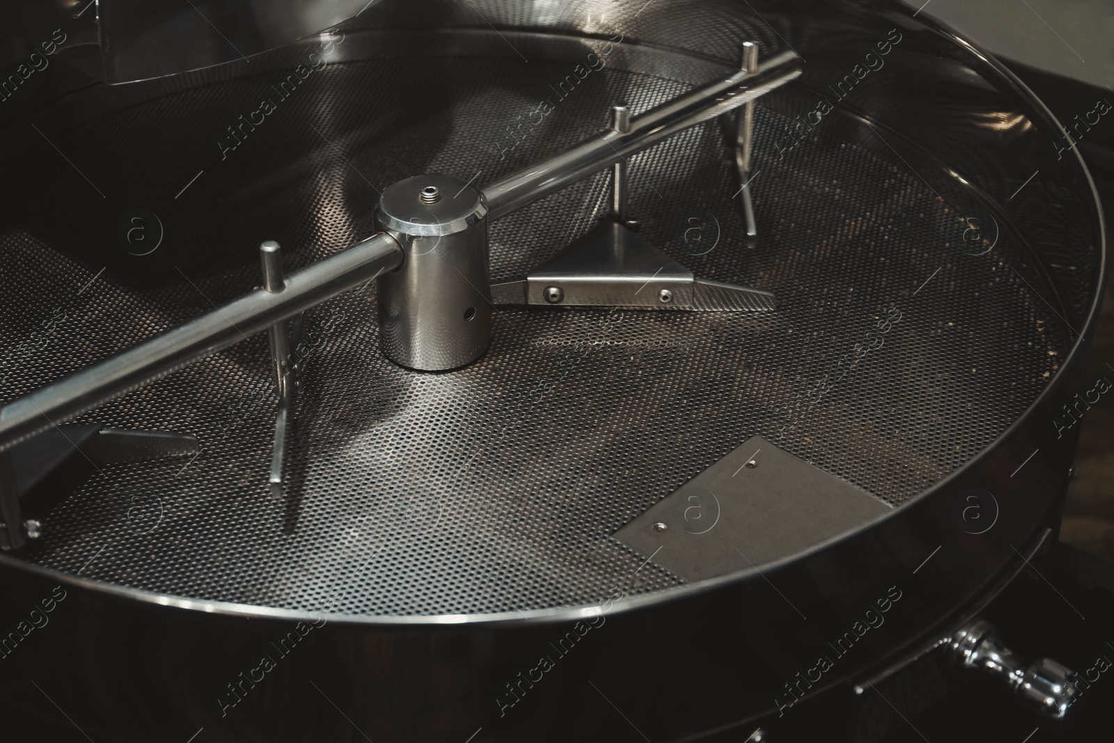 Photo of Stainless coffee roaster machine indoors. Modern device