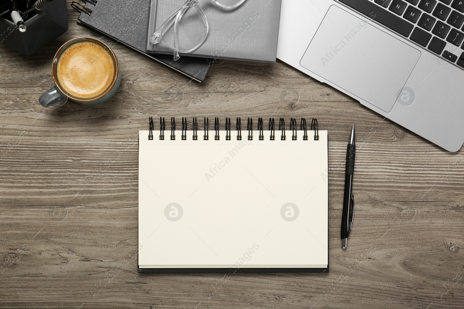 Photo of Flat lay composition with notebooks and laptop on wooden table