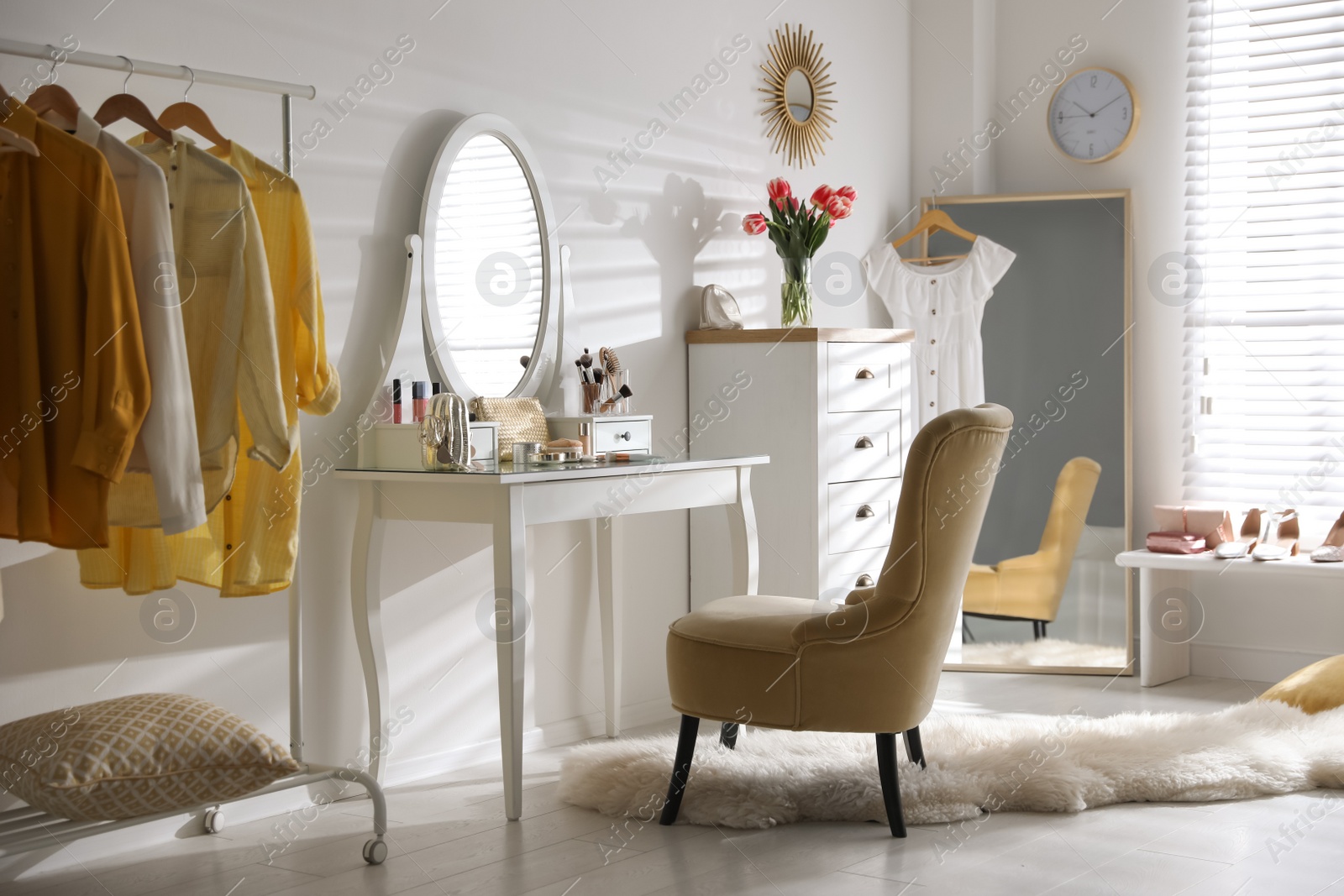 Photo of Stylish room interior with elegant dressing table, mirror and comfortable chair