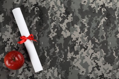 Photo of Apple and diploma on camouflage background, flat lay with space for text. Military education concept