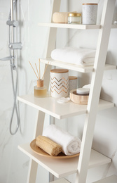 Shelving unit with different items in bathroom interior