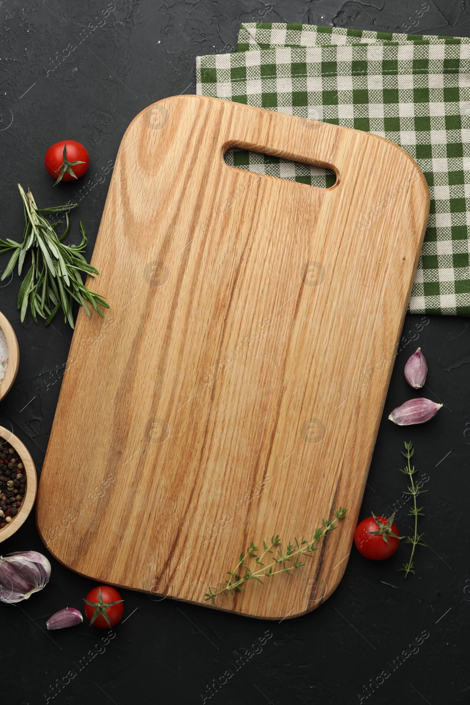 Photo of Cutting board, fresh tomatoes and different spices on grey textured table, flat lay