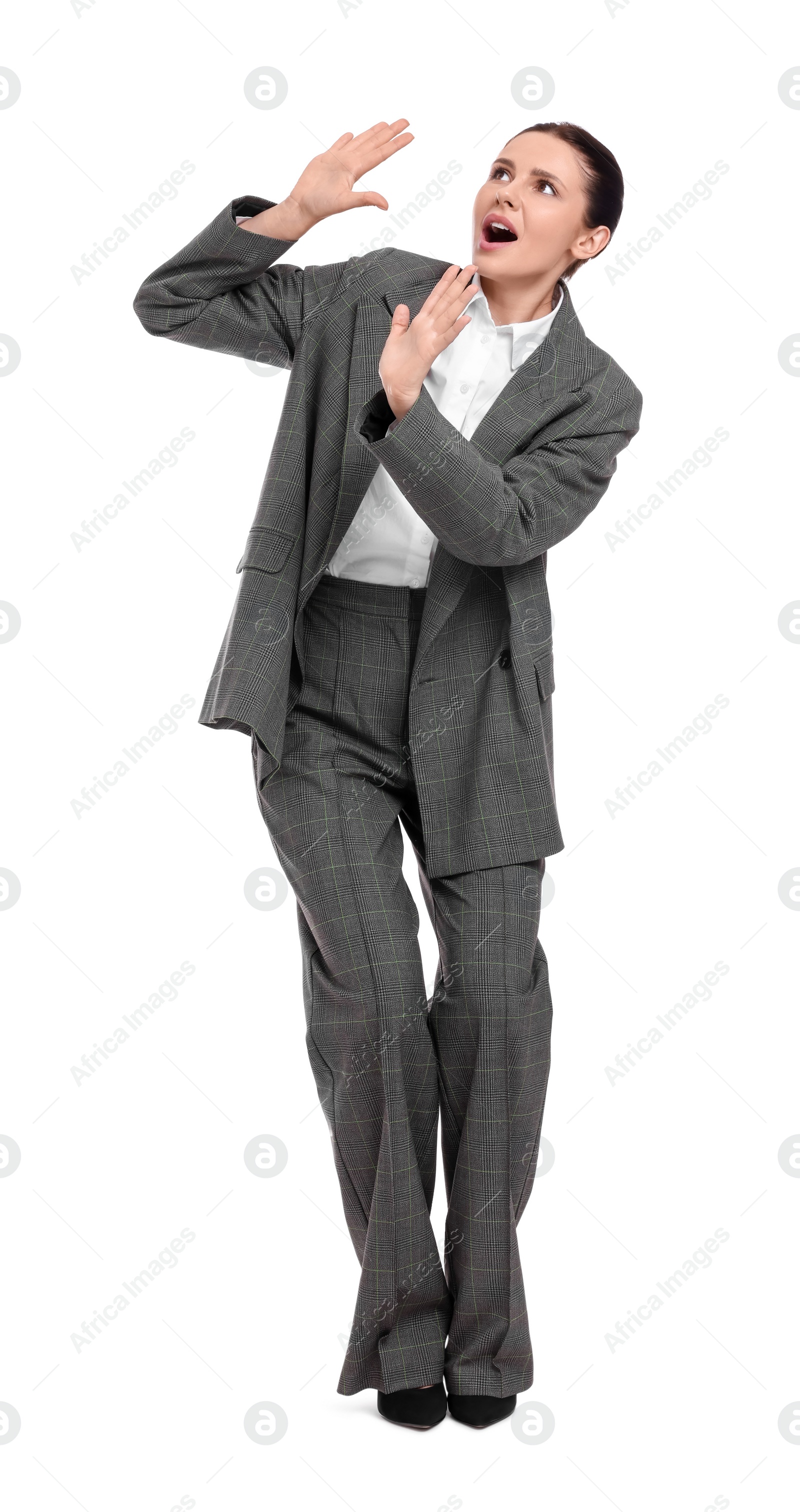 Photo of Beautiful emotional businesswoman in suit avoiding something on white background