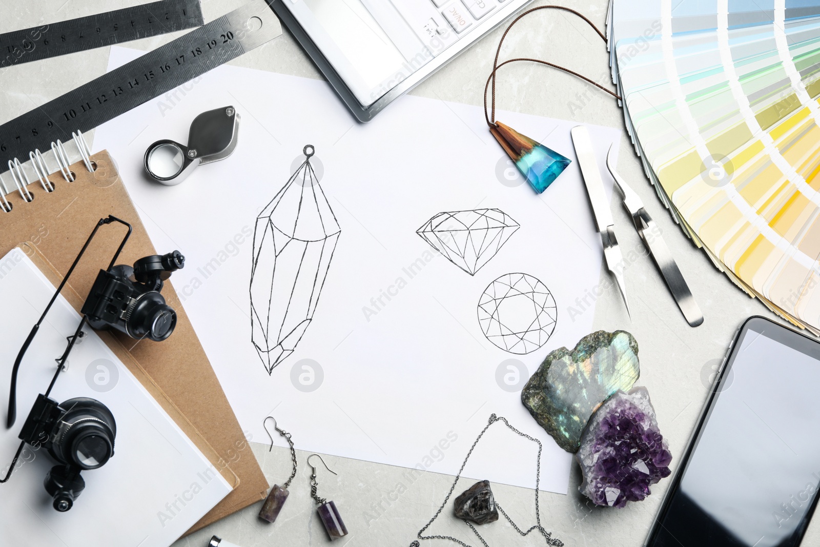 Photo of Flat lay composition with drawing of jewelry on light grey table. Designer's workplace