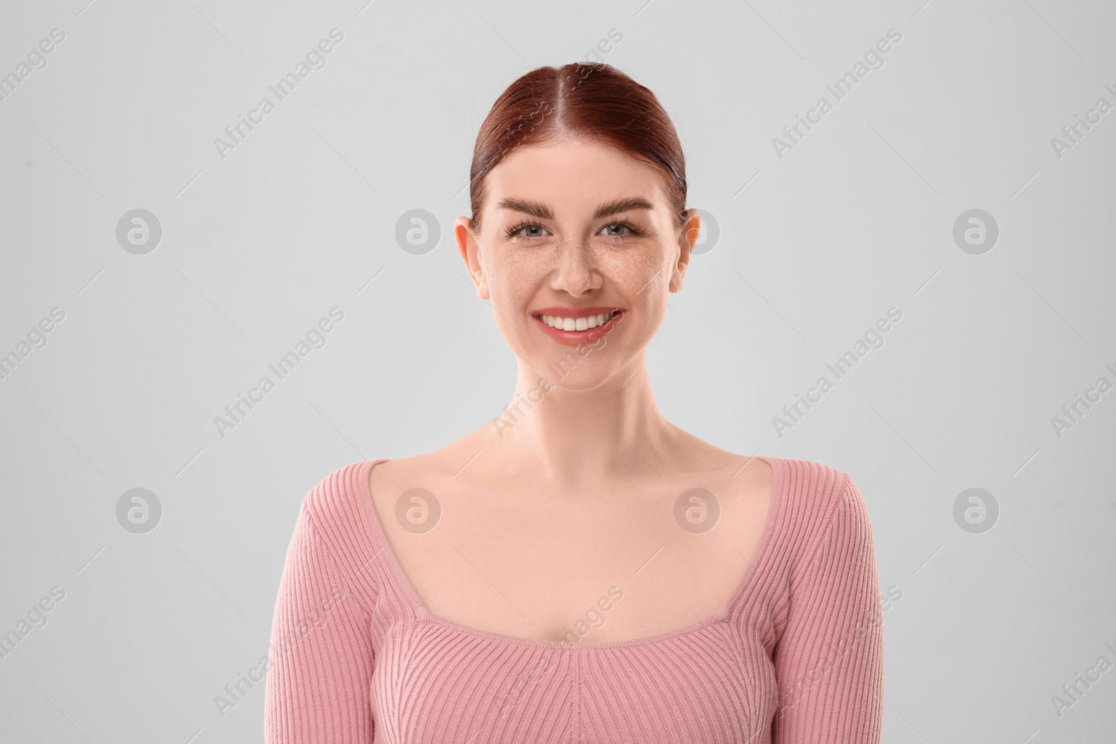 Photo of Portrait of smiling woman on light background