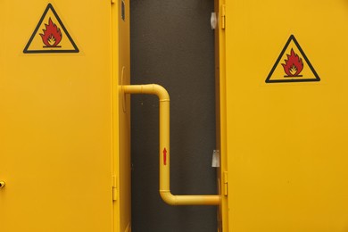 Photo of Yellow gas distribution cabinet near brown wall