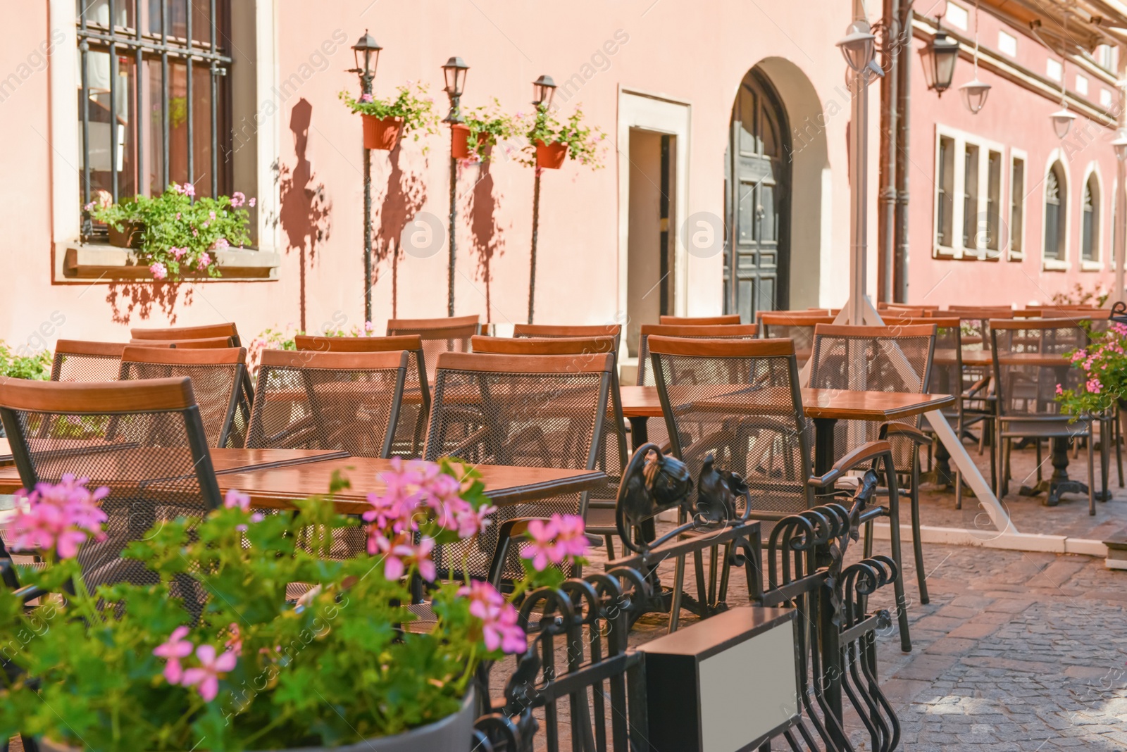 Photo of Outdoor cafe with beautiful flowers and comfortable furniture