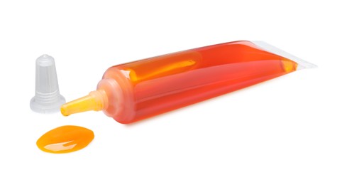 Photo of Tube with orange food coloring isolated on white