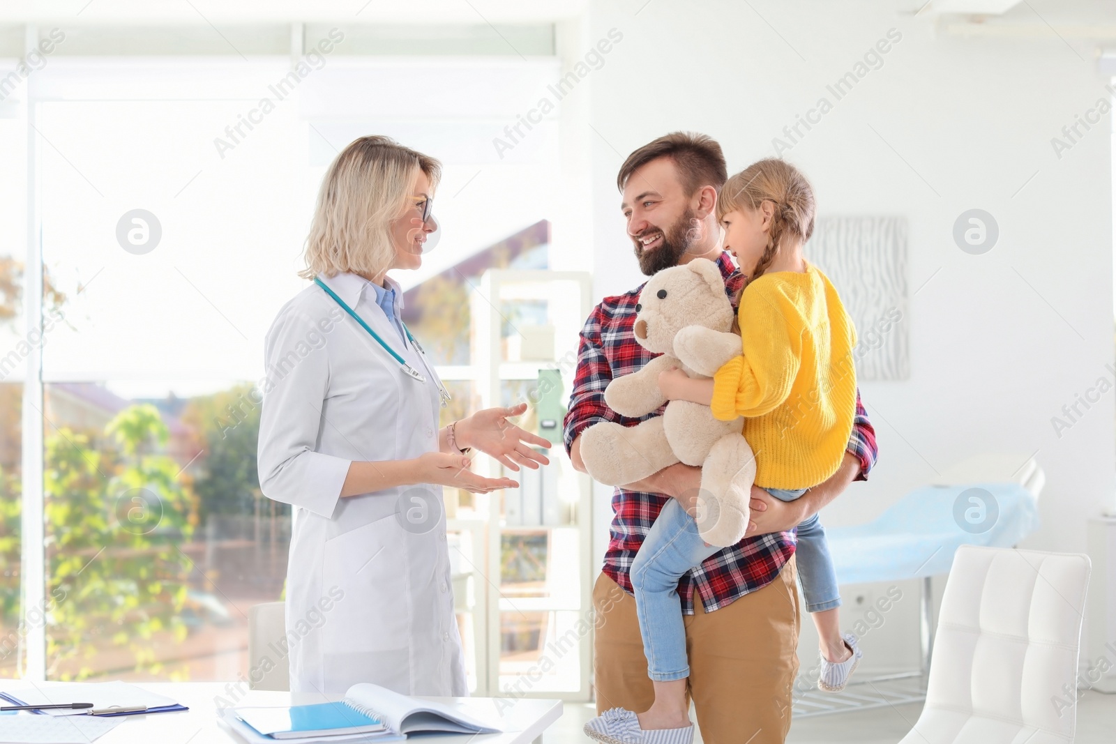 Photo of Little girl with father visiting children's doctor in hospital