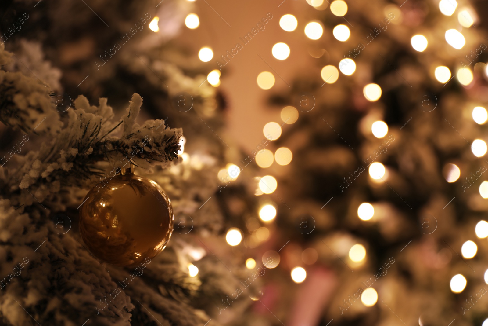 Photo of Closeup view of beautifully decorated Christmas tree indoors