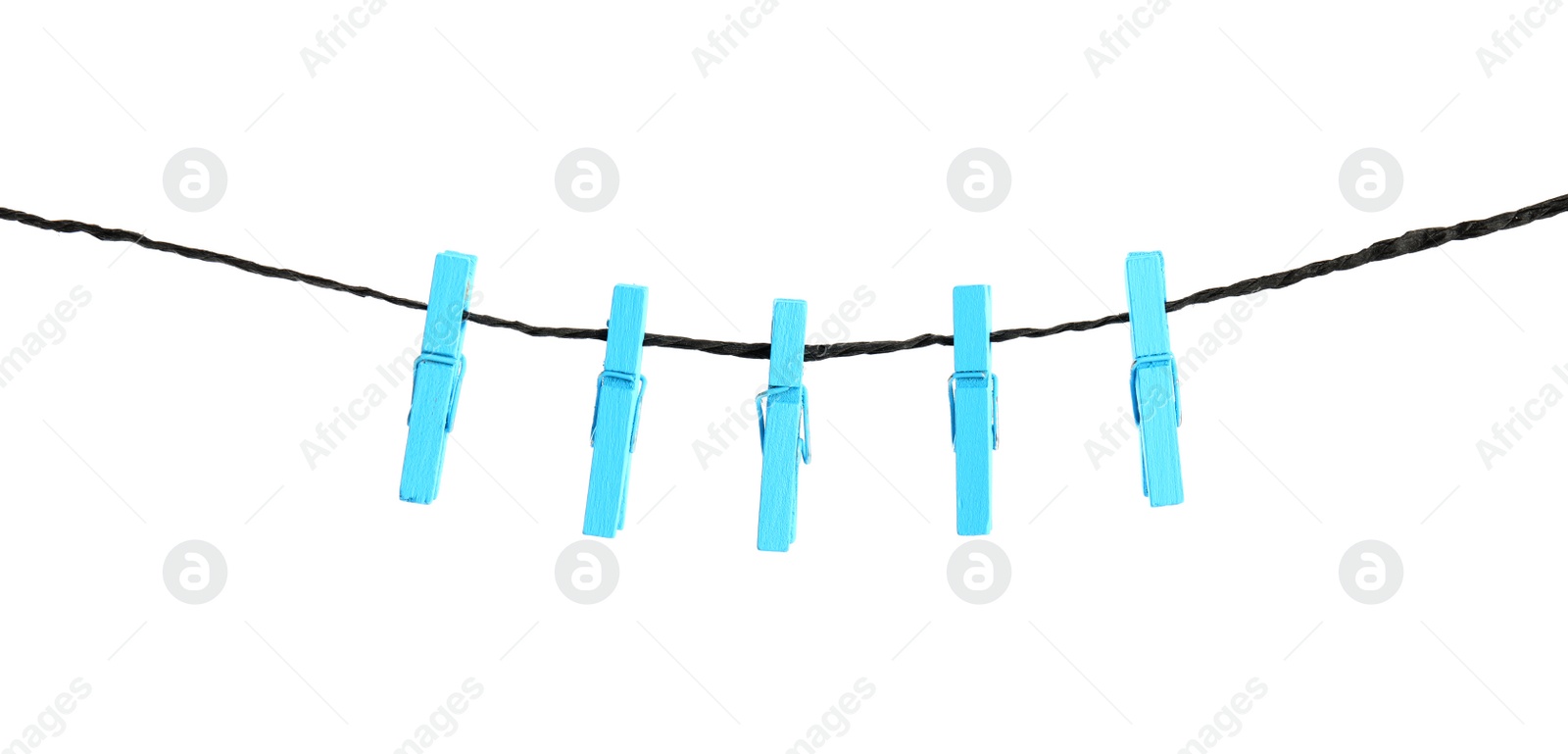 Photo of Many light blue wooden clothespins on rope against white background