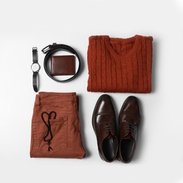 Photo of Stylish male autumn outfit and accessories on white background, flat lay. Trendy warm clothes
