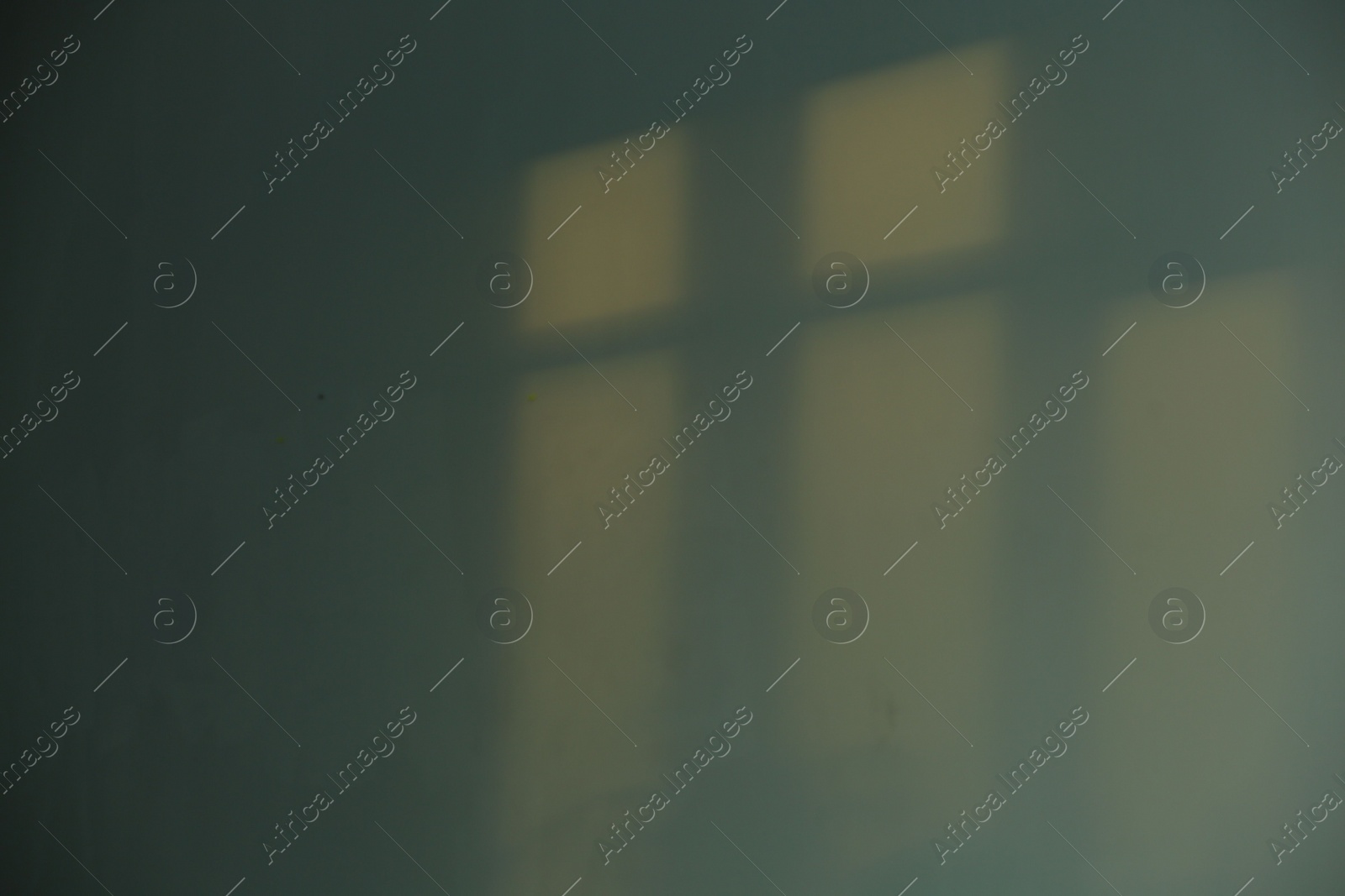 Photo of Light and shadows from window on wall indoors