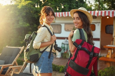 Photo of Young travelers with backpacks outdoors. Summer trip