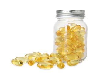 Photo of Bottle and pile of softgel capsules isolated on white