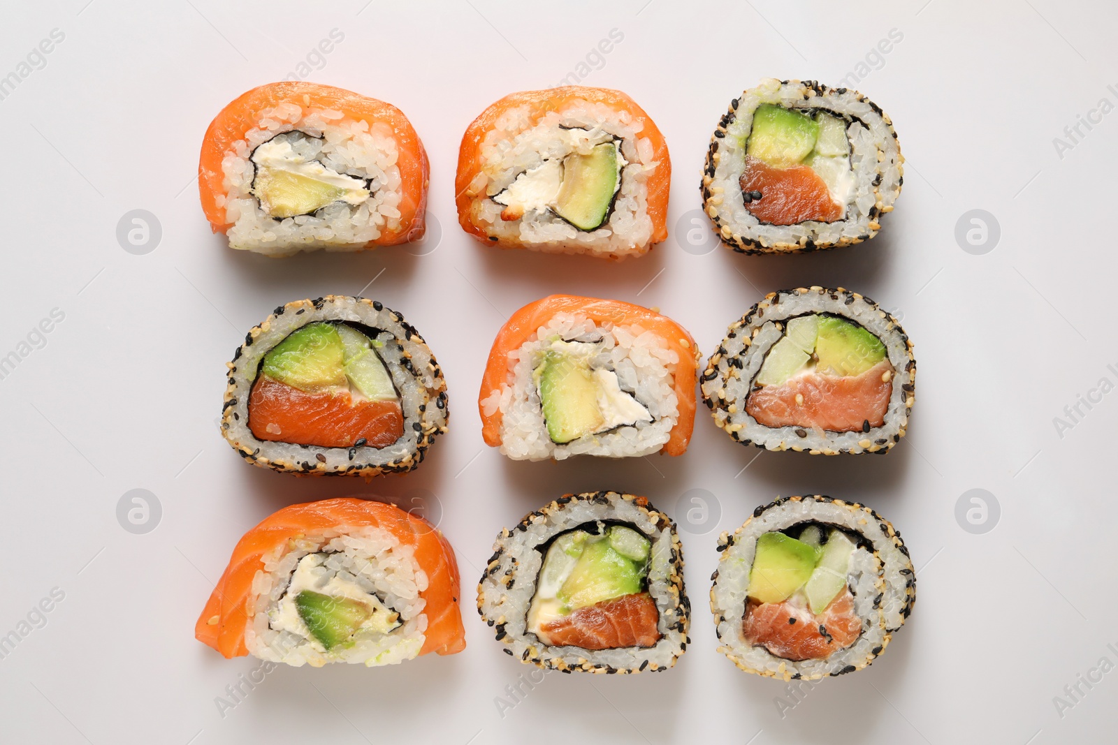 Photo of Delicious sushi rolls on white background, flat lay