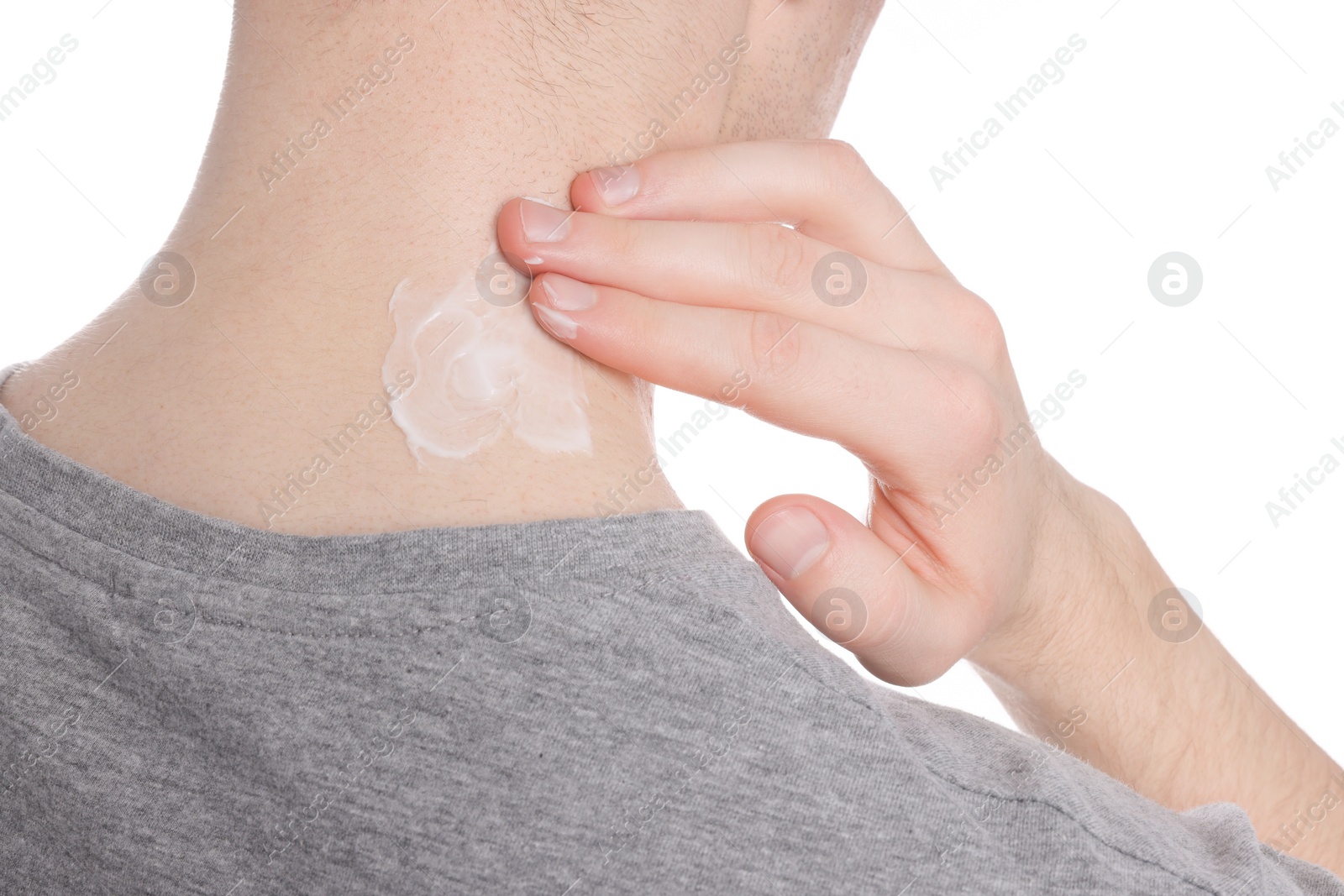 Photo of Man applying ointment onto his neck on white background, closeup