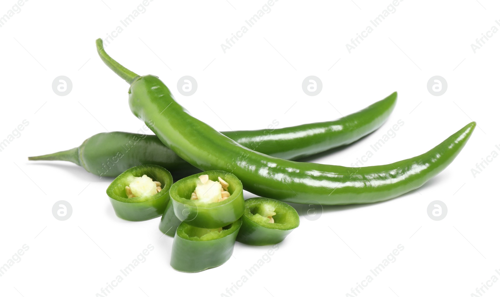 Photo of Cut and whole green hot chili peppers on white background