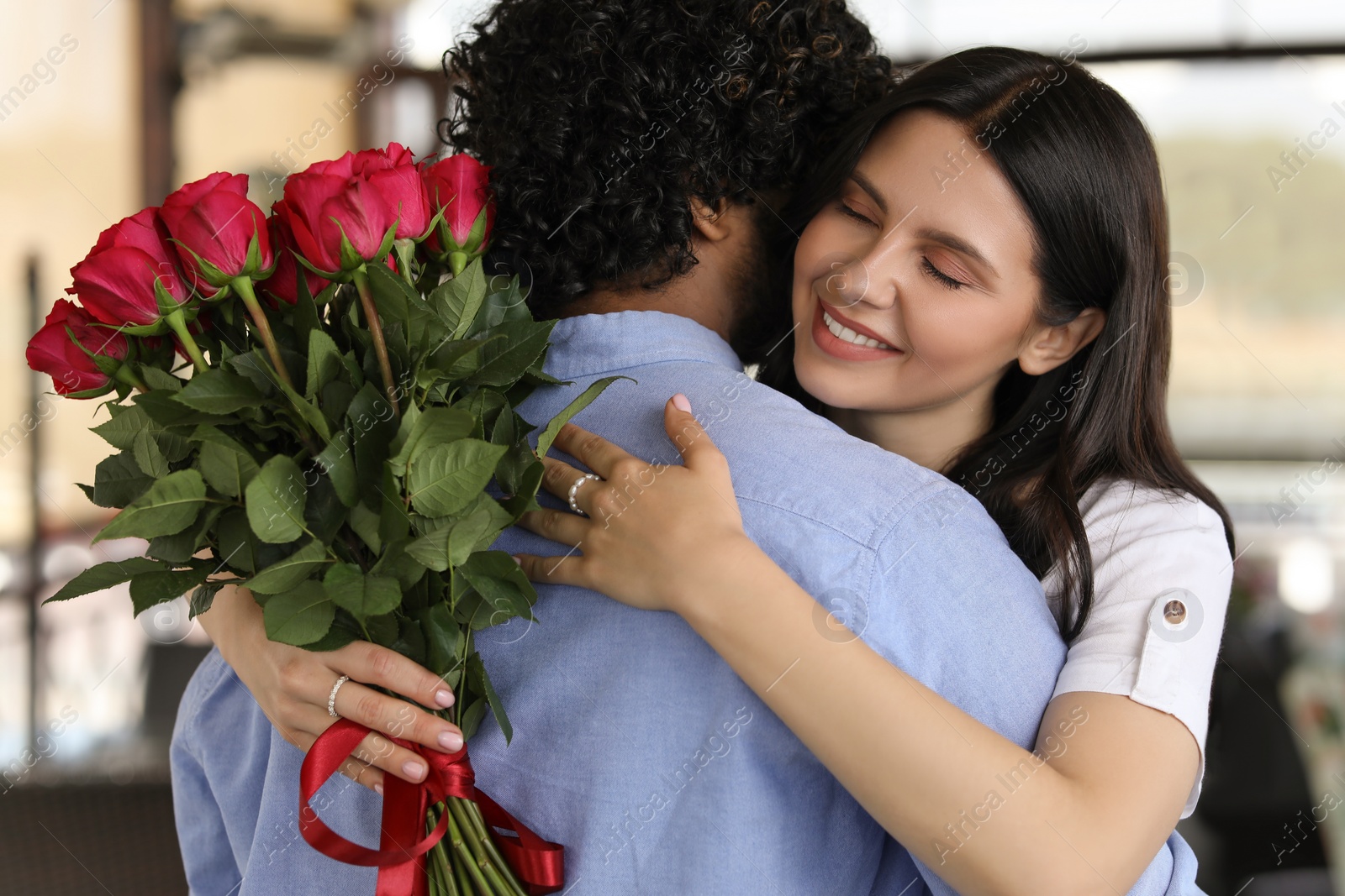 Photo of International dating. Happy couple hugging in restaurant