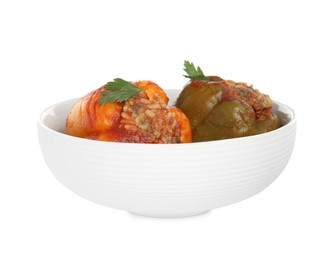 Photo of Delicious stuffed peppers with parsley in bowl isolated on white