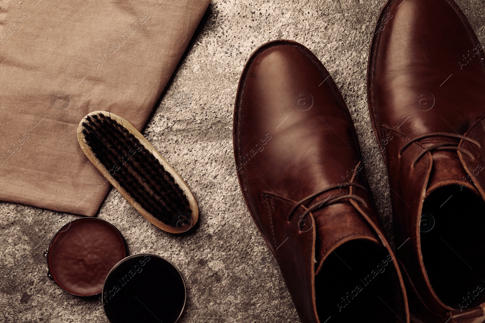 Image of Flat lay composition with shoe care accessories and footwear on stone background