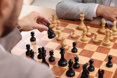 Photo of Men playing chess during tournament at chessboard, closeup
