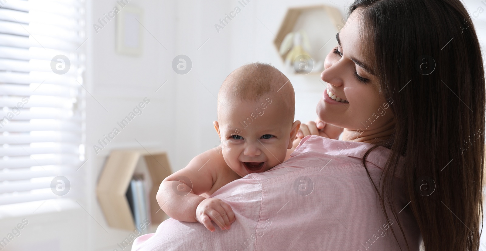 Image of Mother with her cute baby at home. Banner design 