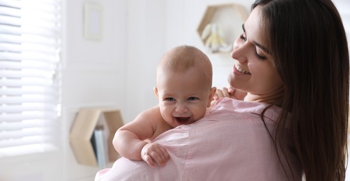 Mother with her cute baby at home. Banner design 