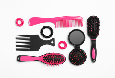 Photo of Composition with hair combs and brushes on white background, top view