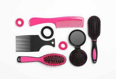 Composition with hair combs and brushes on white background, top view