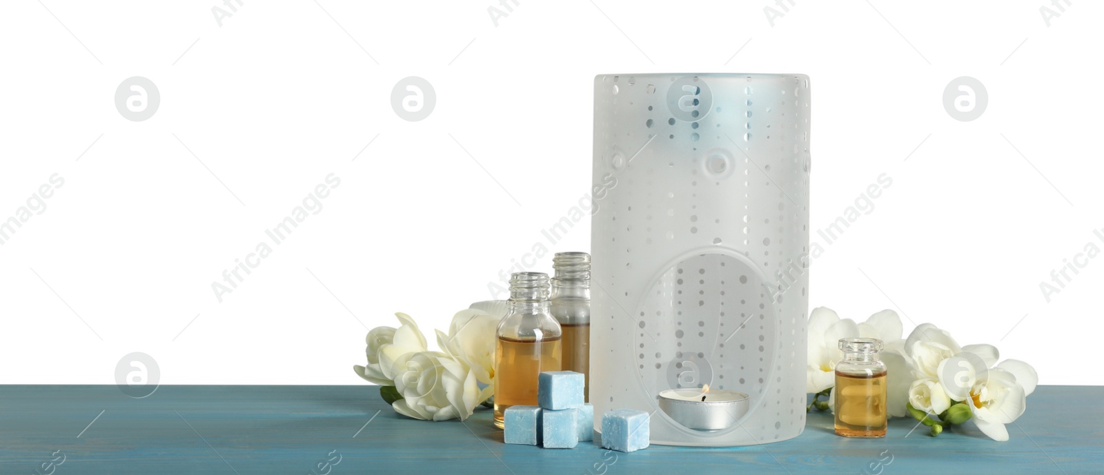 Photo of Composition with aroma lamp on blue wooden table against light grey background, space for text