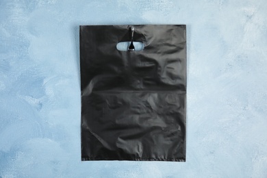 Photo of Plastic bag hanging on color wall. Mock up for design