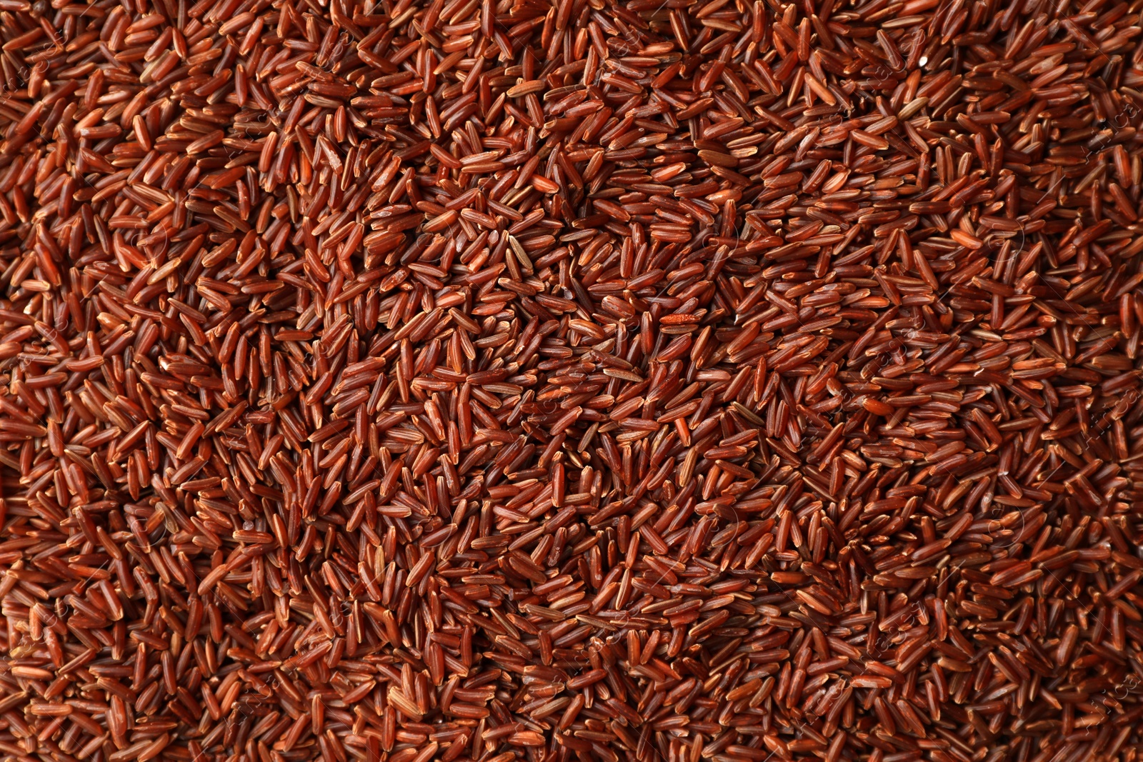 Photo of Raw brown rice as background, top view