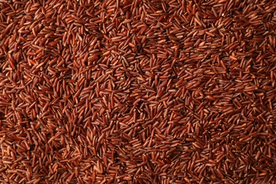 Photo of Raw brown rice as background, top view