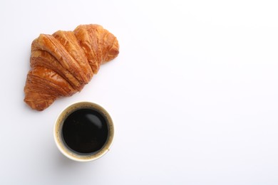 Photo of Delicious fresh croissant and paper cup of coffee on white background, flat lay. Space for text