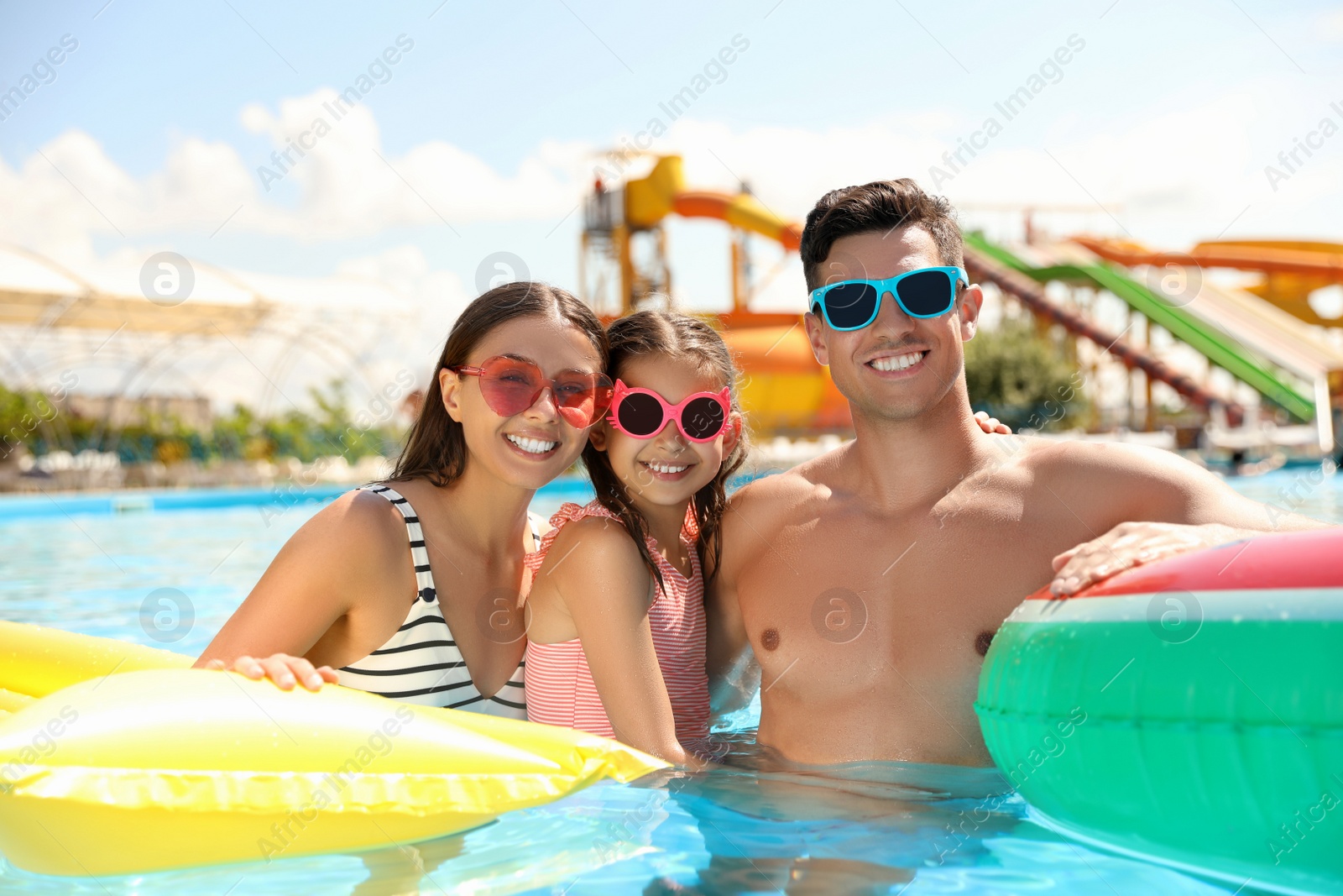Photo of Happy family in swimming pool. Summer vacation