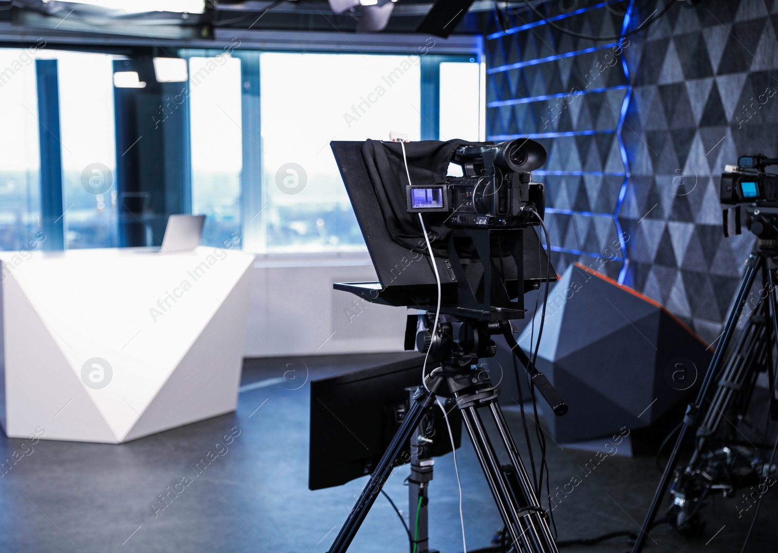 Photo of Modern video recording studio with professional equipment, focus on camera