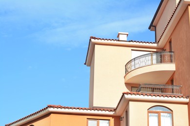 Exterior of beautiful residential buildings with balconies against blue sky