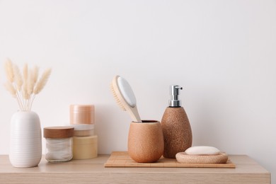 Different bath accessories and personal care products on wooden table