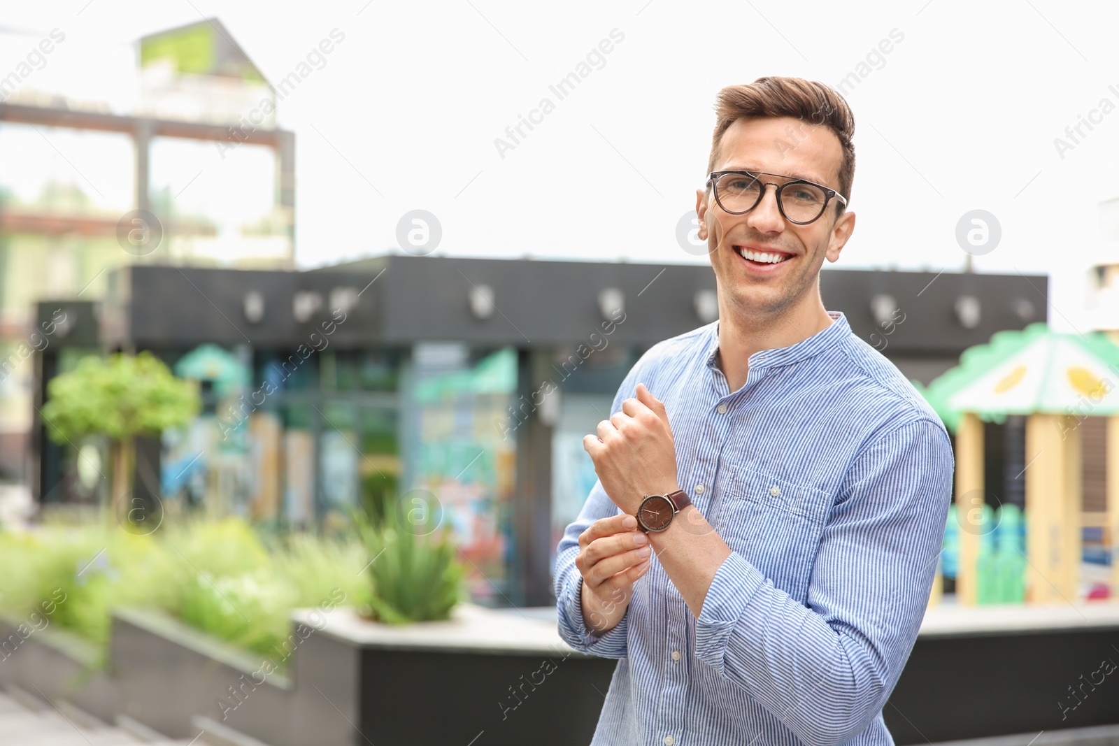 Photo of Portrait of attractive young man in stylish outfit outdoors