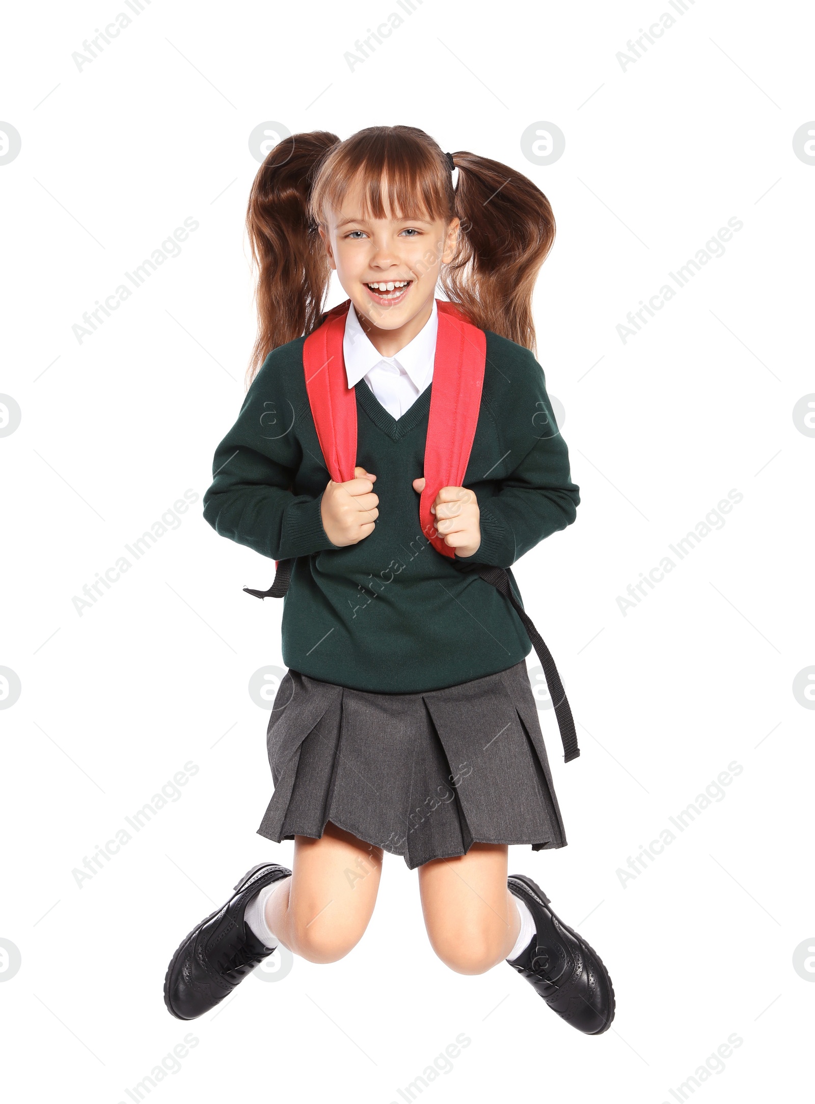 Photo of Little girl in stylish school uniform on white background