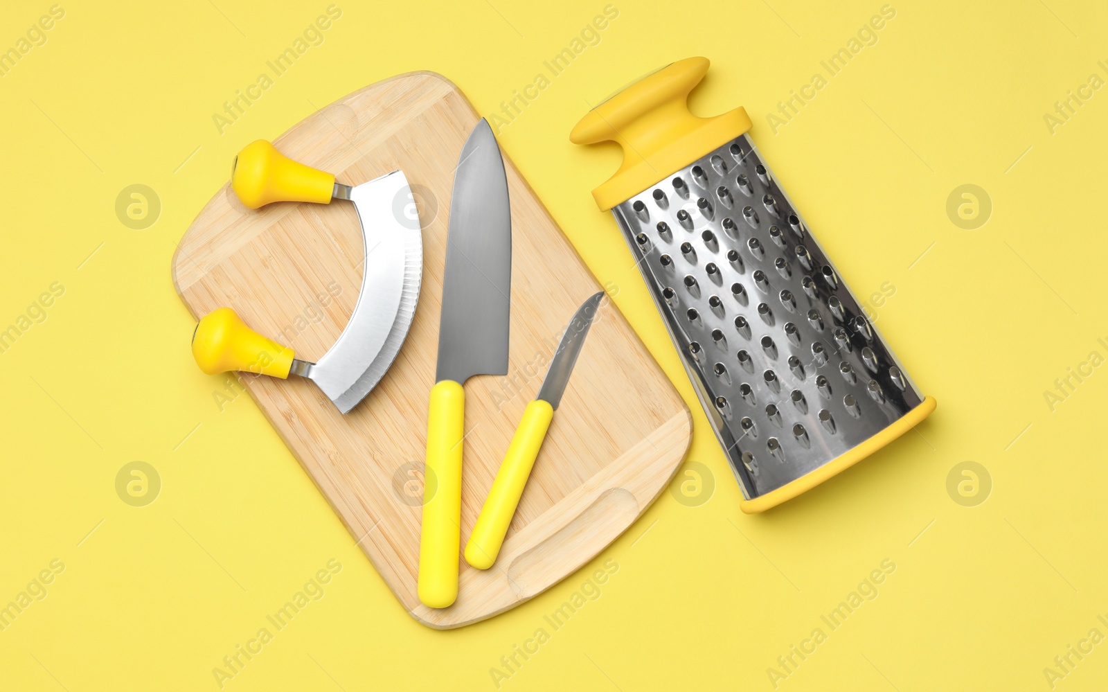 Photo of Set of modern cooking utensils on yellow background, flat lay