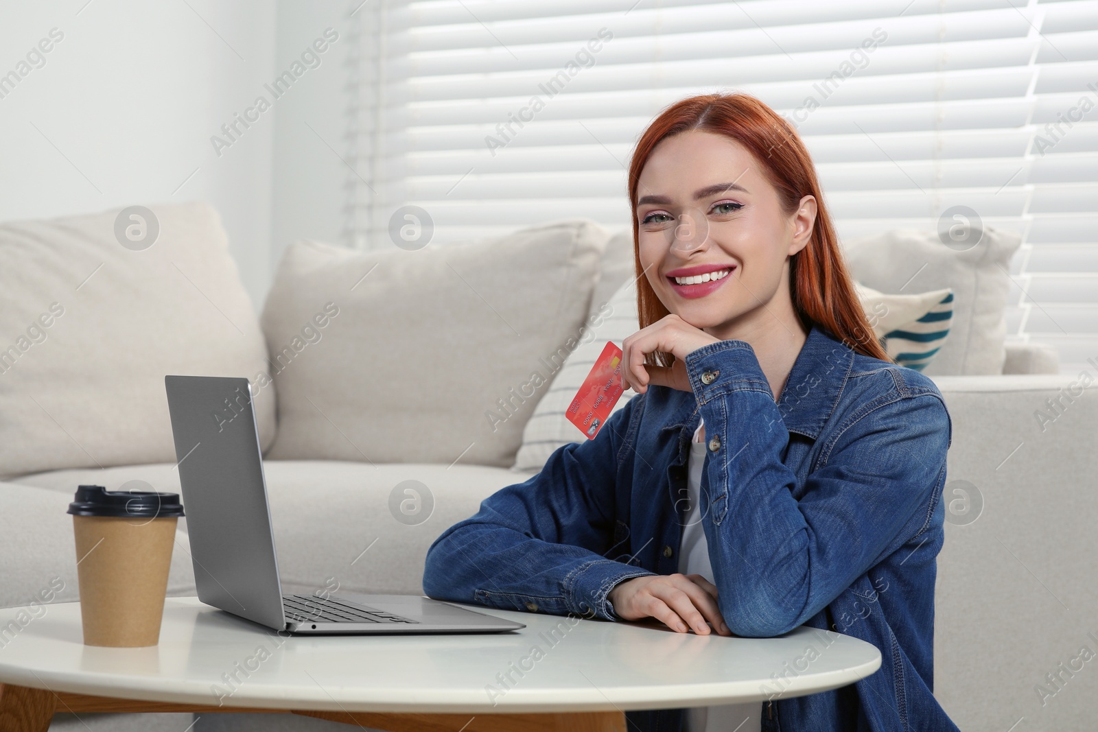 Photo of Happy woman with credit card near laptop at home, space for text. Online shopping