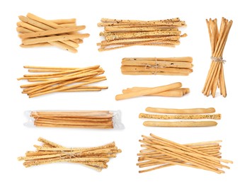 Image of Set with delicious crispy grissini sticks on white background