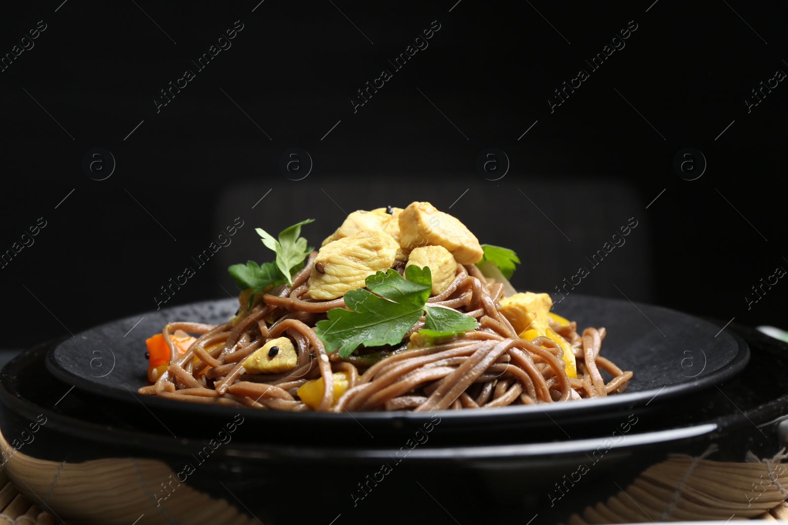 Photo of Stir-fry. Tasty noodles with meat and vegetables on table