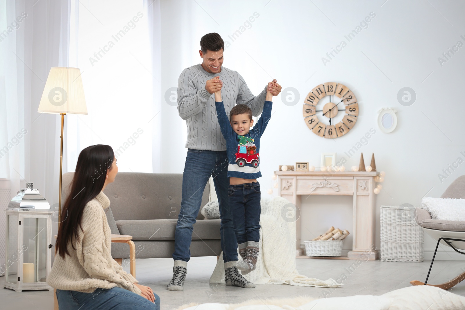 Photo of Happy family with little son having fun at home. Winter vacation